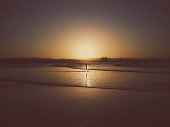 Scenic view of sea against clear sky during sunset
