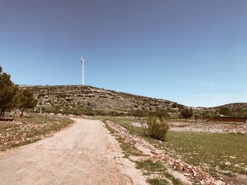 Road by landscape against sky