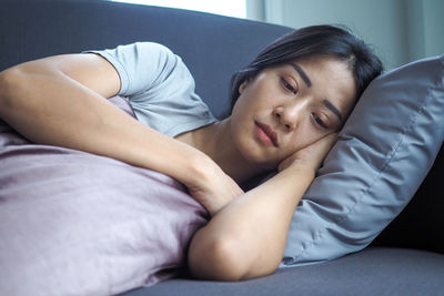 Young woman sleeping on bed