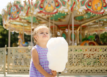 Cute girl holding cotton candy