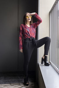 Portrait of beautiful model posing against wall