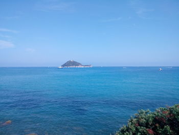 Scenic view of sea against clear blue sky