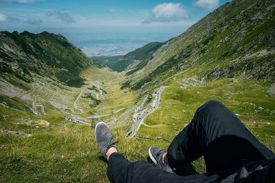 Low section of man sitting on mountain