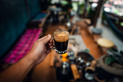 Cropped hand holding coffee