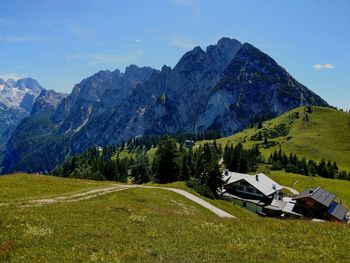 Scenic view of field and mountains against sky