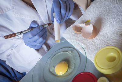 High angle view of man holding ice cream on table