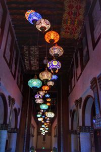 Low angle view of illuminated lanterns hanging on ceiling at night