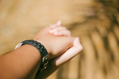 Close-up of woman hand against blurred background