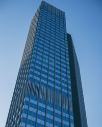 Low angle view of modern building against clear blue sky