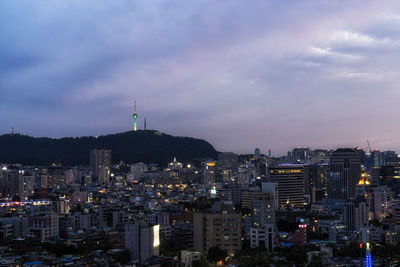 Skyscrapers against cloudy sky