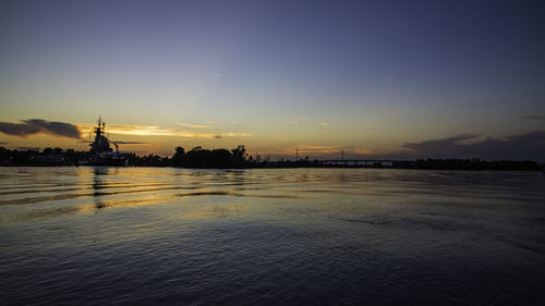 Scenic view of river against sky during sunset