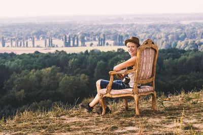 Rear view of woman sitting on landscape