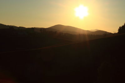 Scenic view of silhouette landscape against clear sky during sunset