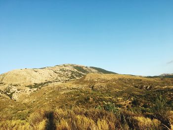 Scenic view of mountain against blue sky