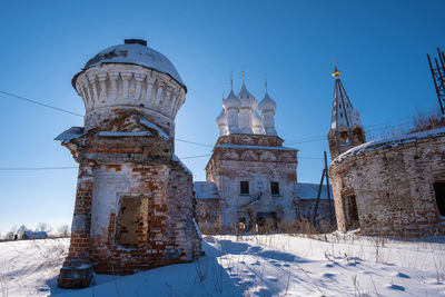 Traditional building against clear blue sky during winter