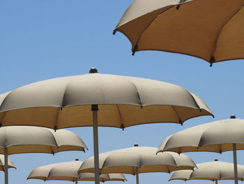 Low angle view of umbrellas against clear sky