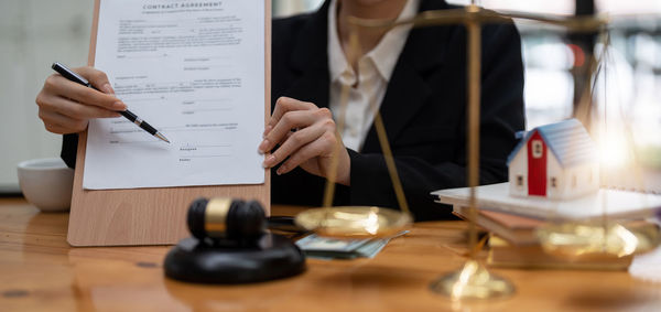 Midsection of lawyer working at table