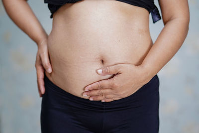 Midsection of woman standing against sun