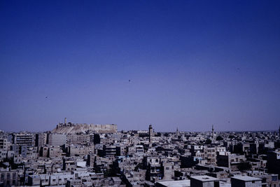 High angle shot of townscape against clear blue sky