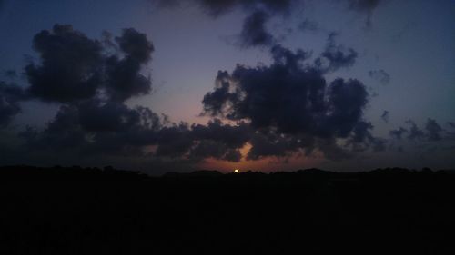 Silhouette of landscape against sunset sky