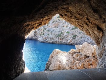 Scenic view of sea seen through cave