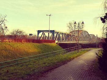 Bridge over trees against sky