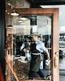 Man standing by window in store