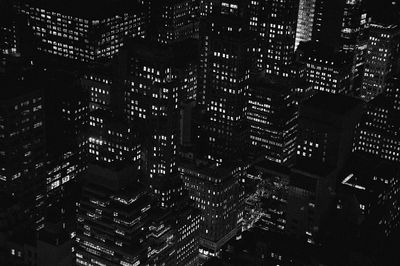 Aerial view of illuminated buildings in city at night