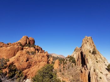 Scenic view of mountains against clear blue sky