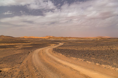 Dirt road passing through a desert