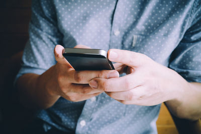 Close-up of man using mobile phone