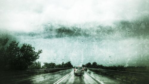 Cars on road against sky