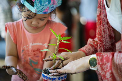 Low section of woman holding hands