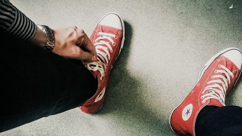 Low section of person standing on tiled floor