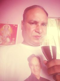 Portrait of a smiling young man drinking glass