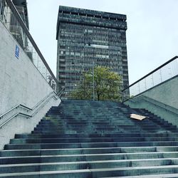 Low angle view of staircase in city against sky