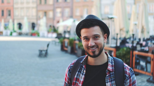 Portrait of smiling young man standing outdoors