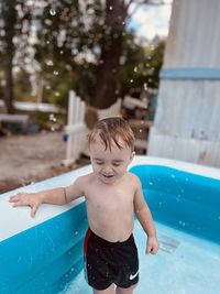 Portrait of boy swimming in pool