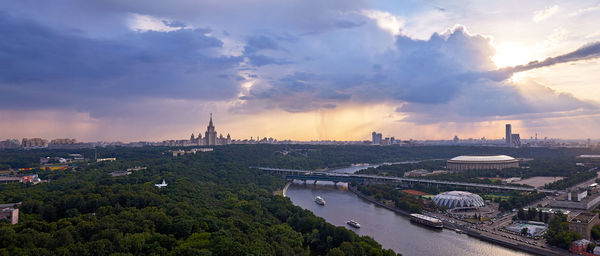 Wide angle panoramic view of moscow river and sparrow hill area under dramatic storm cloudy sky