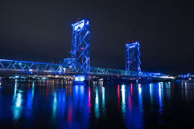 Low angle view of illuminated memorial bridge over river