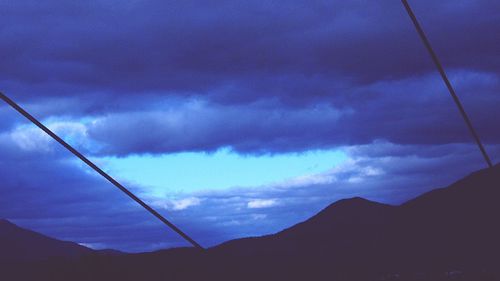 Low angle view of silhouette mountain against sky