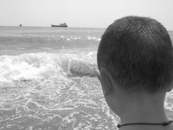 Rear view of man looking at sea