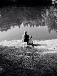 High angle view of father and son fishing in lake