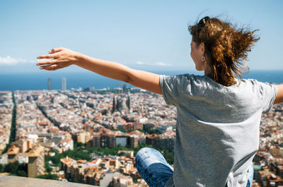 Rear view of woman looking at barcelona cityscape