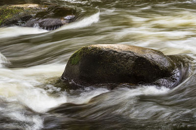 Scenic view of river flowing through rocks