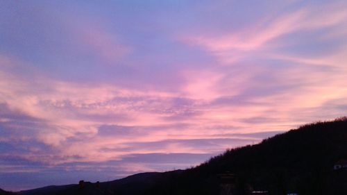 Scenic view of silhouette mountains against sky at sunset