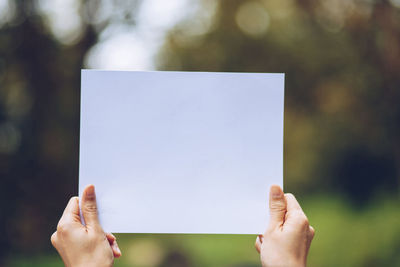 Close-up of hand holding paper