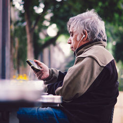 Side view of man using mobile phone