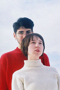 Young couple looking down against gray background