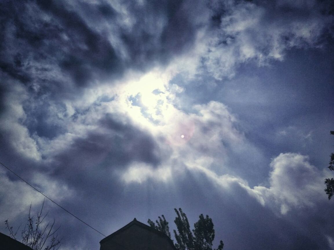 low angle view, sky, cloud - sky, building exterior, built structure, architecture, cloudy, cloud, high section, nature, house, silhouette, beauty in nature, outdoors, weather, no people, blue, building, sunlight, residential structure